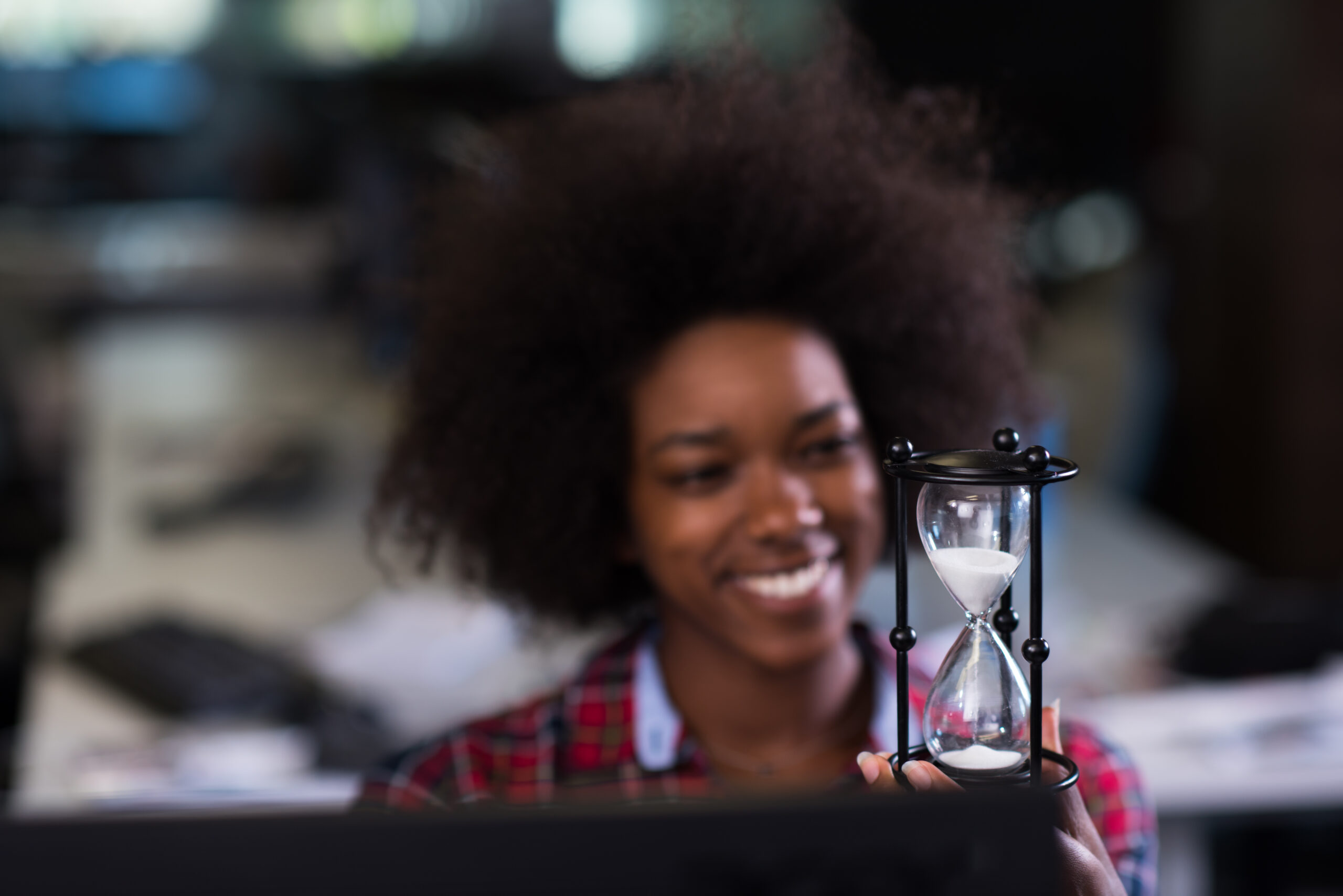 young woman at office looking at sand clock young woman at startup business office looking at sand clock
